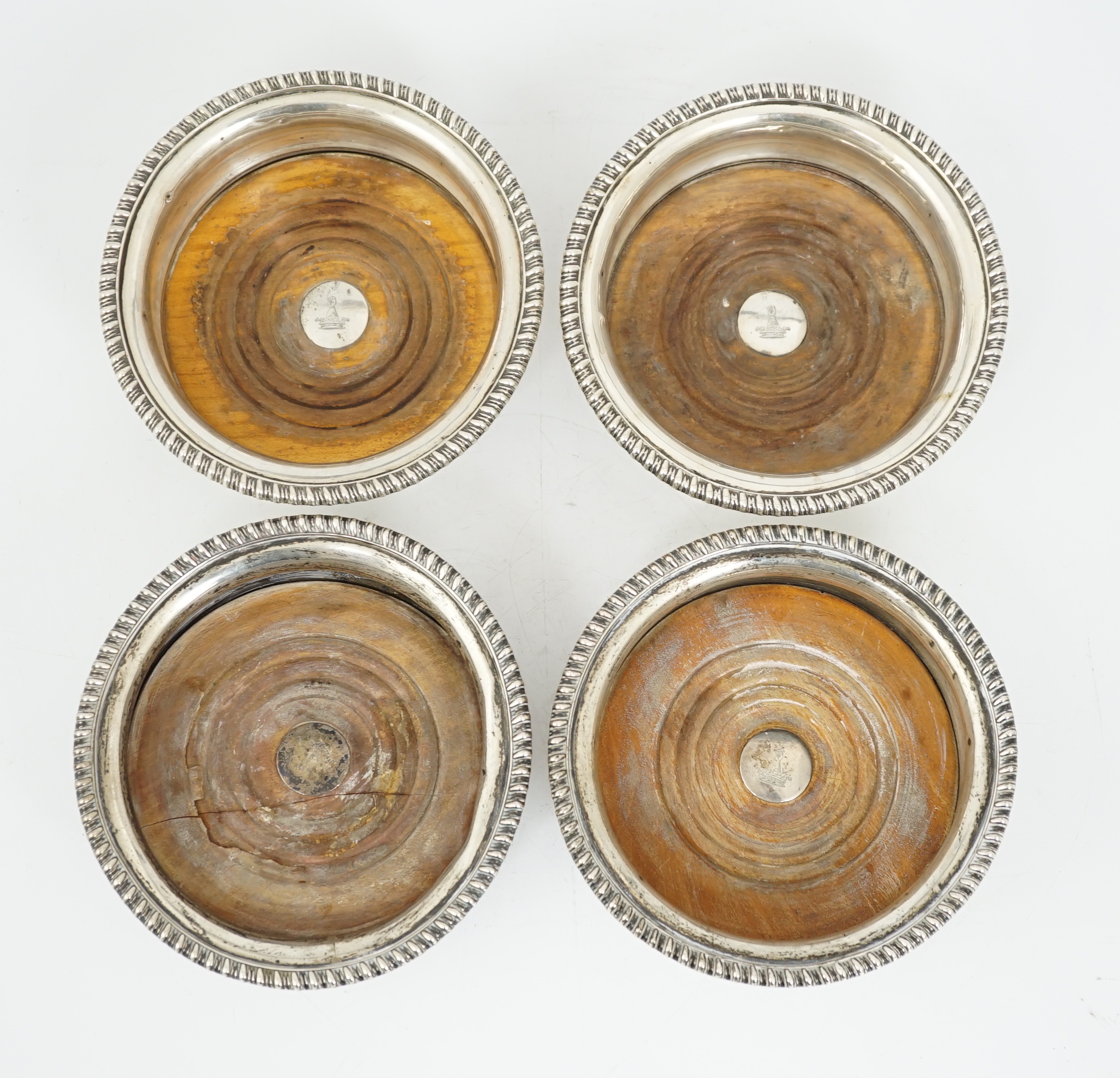 Two pairs of early 19th century silver mounted wine coasters